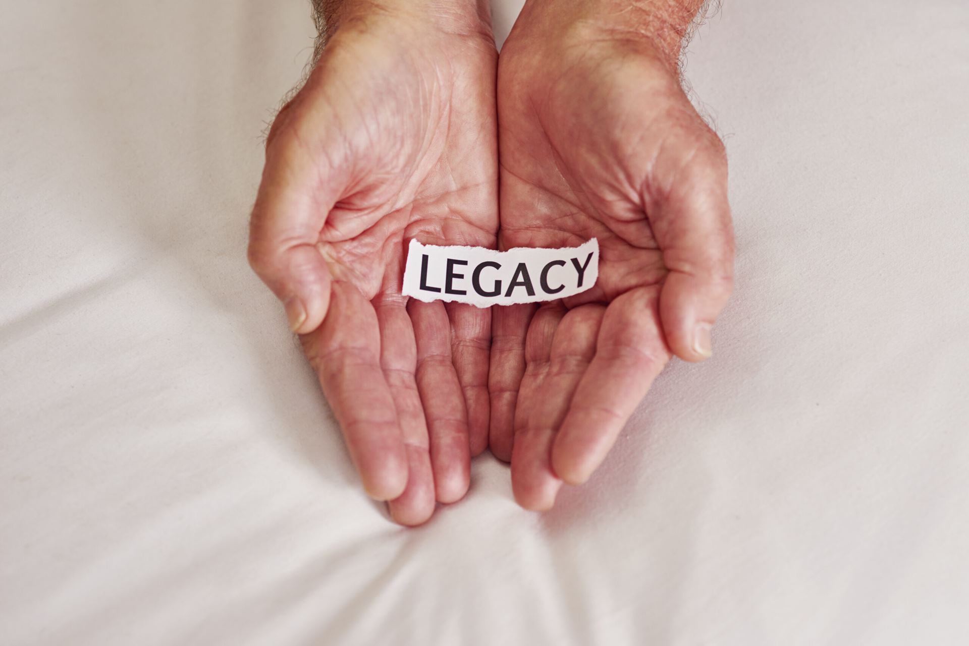 Open hands with the word "Legacy" on them