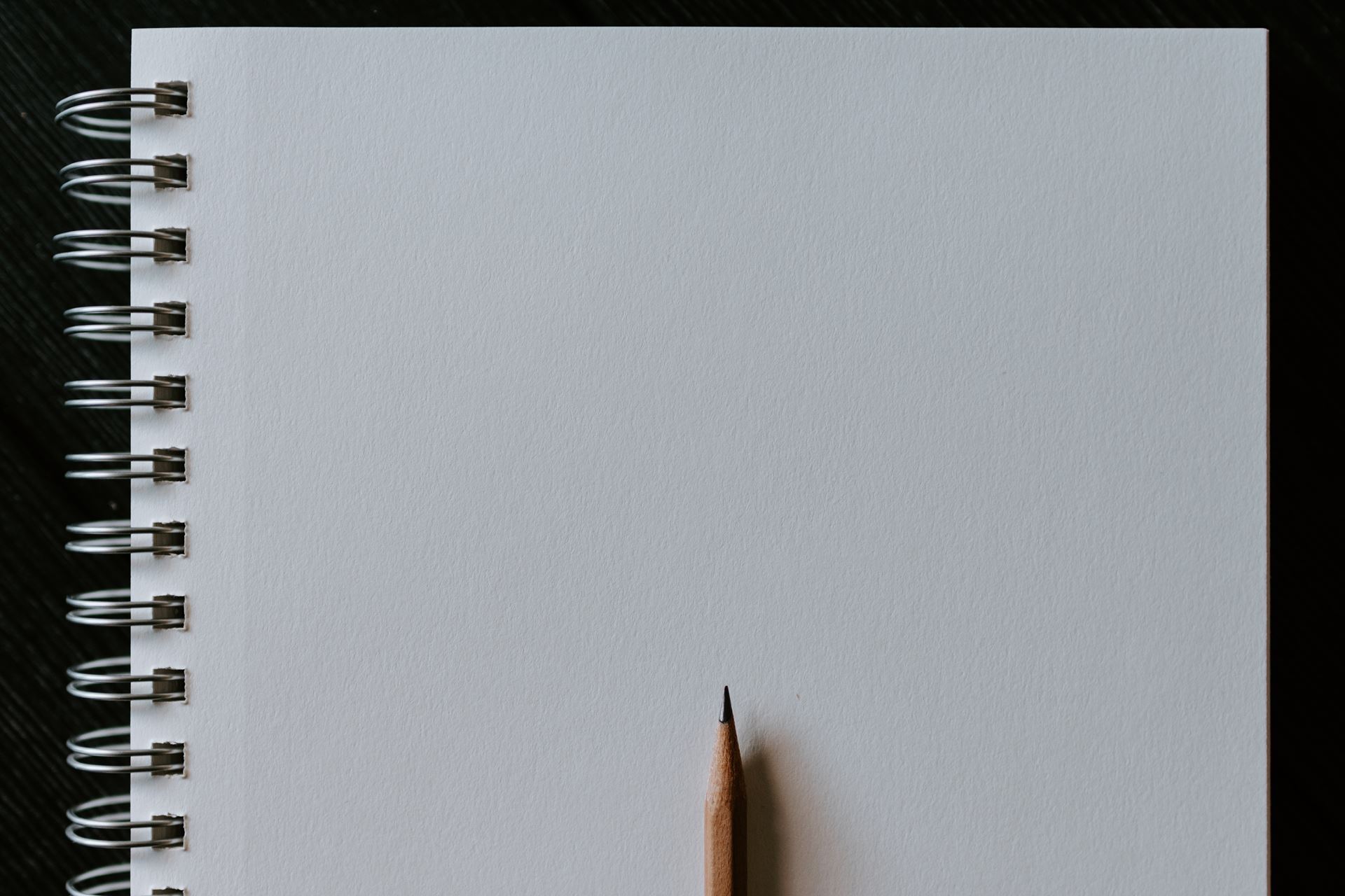 Blank piece of paper with sharpened pencil at the bottom