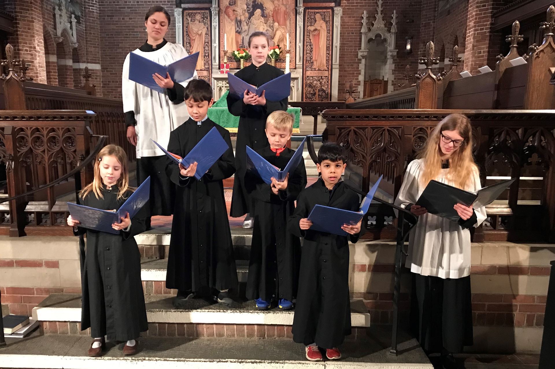 Seven robed children singing in the chancel of Parish of the Epiphany