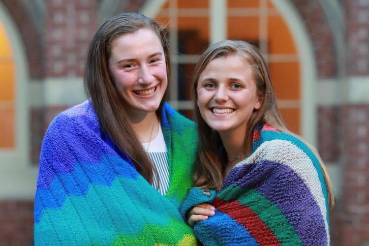 Two of Parish of the Epiphany's 2019 graduating high school seniors, wrapped in prayer shawls