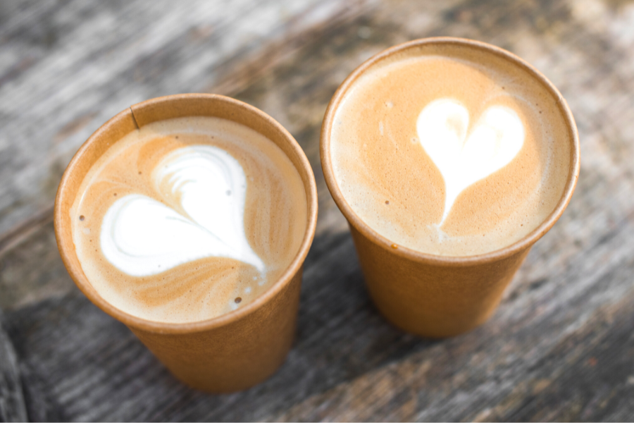 Two cups of coffee with foam hearts